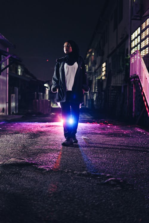 Portrait of a Female Model Wearing a Hijab Standing Outdoors at Night