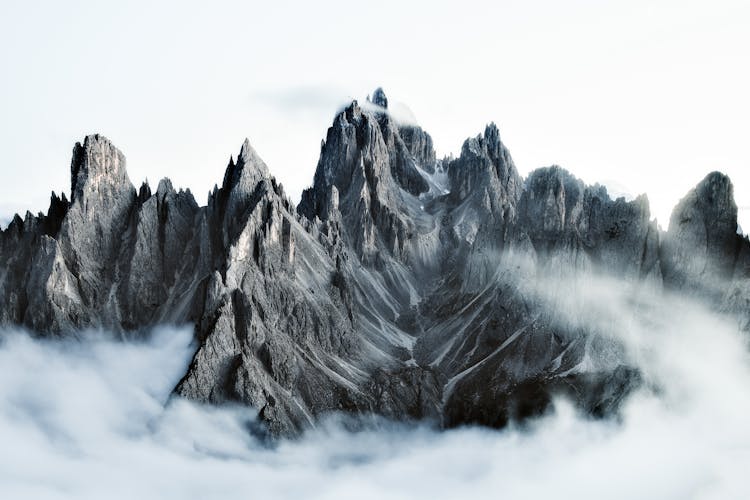 Rocky Steep Dolomite Mountains Above The Clouds