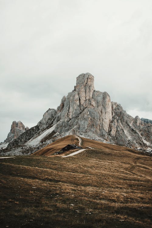 Wooden Cottage by the Road in the Italian Dolomites