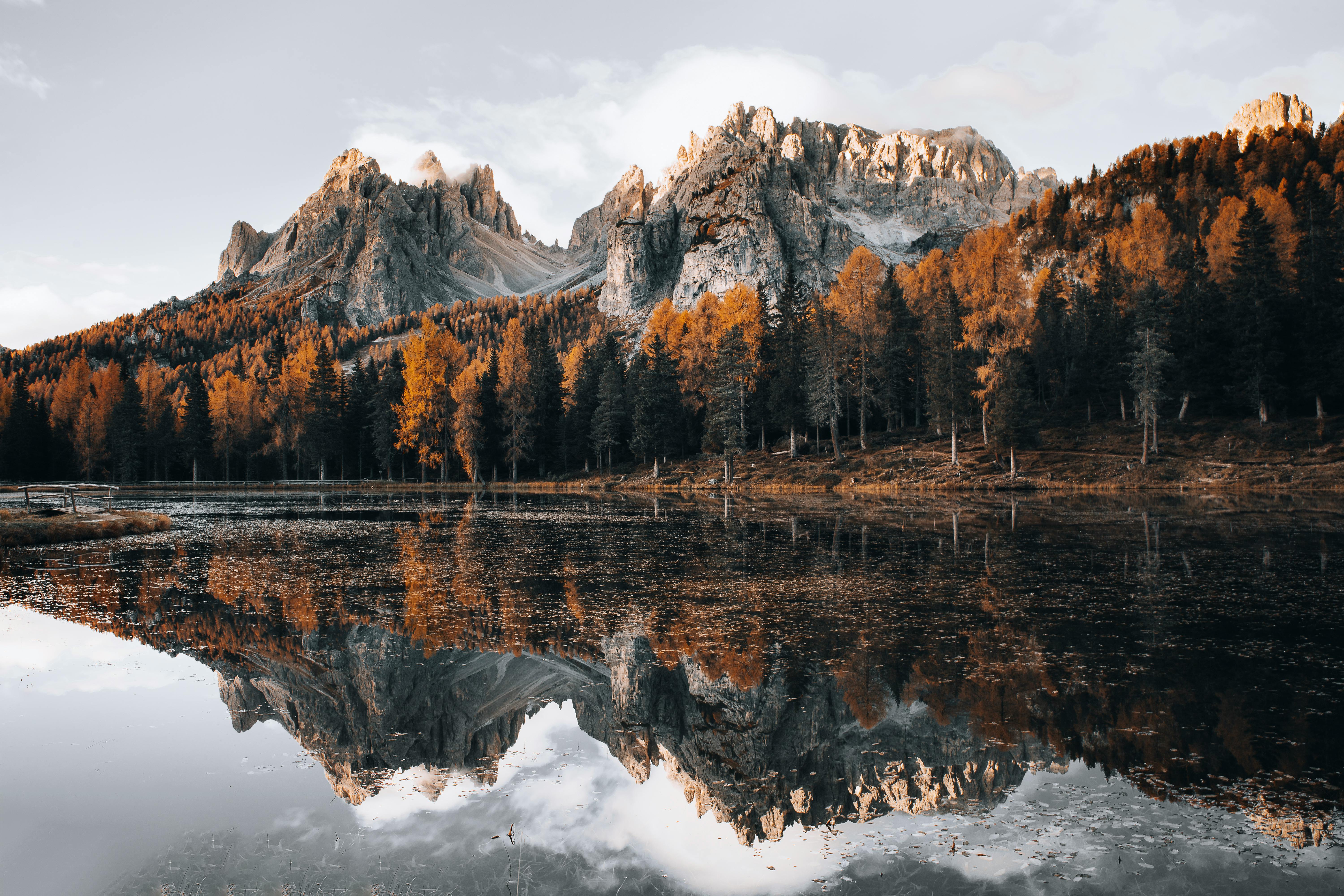 Stunning reflection of mountains in a tranquil lake in Dolomites, Italy.