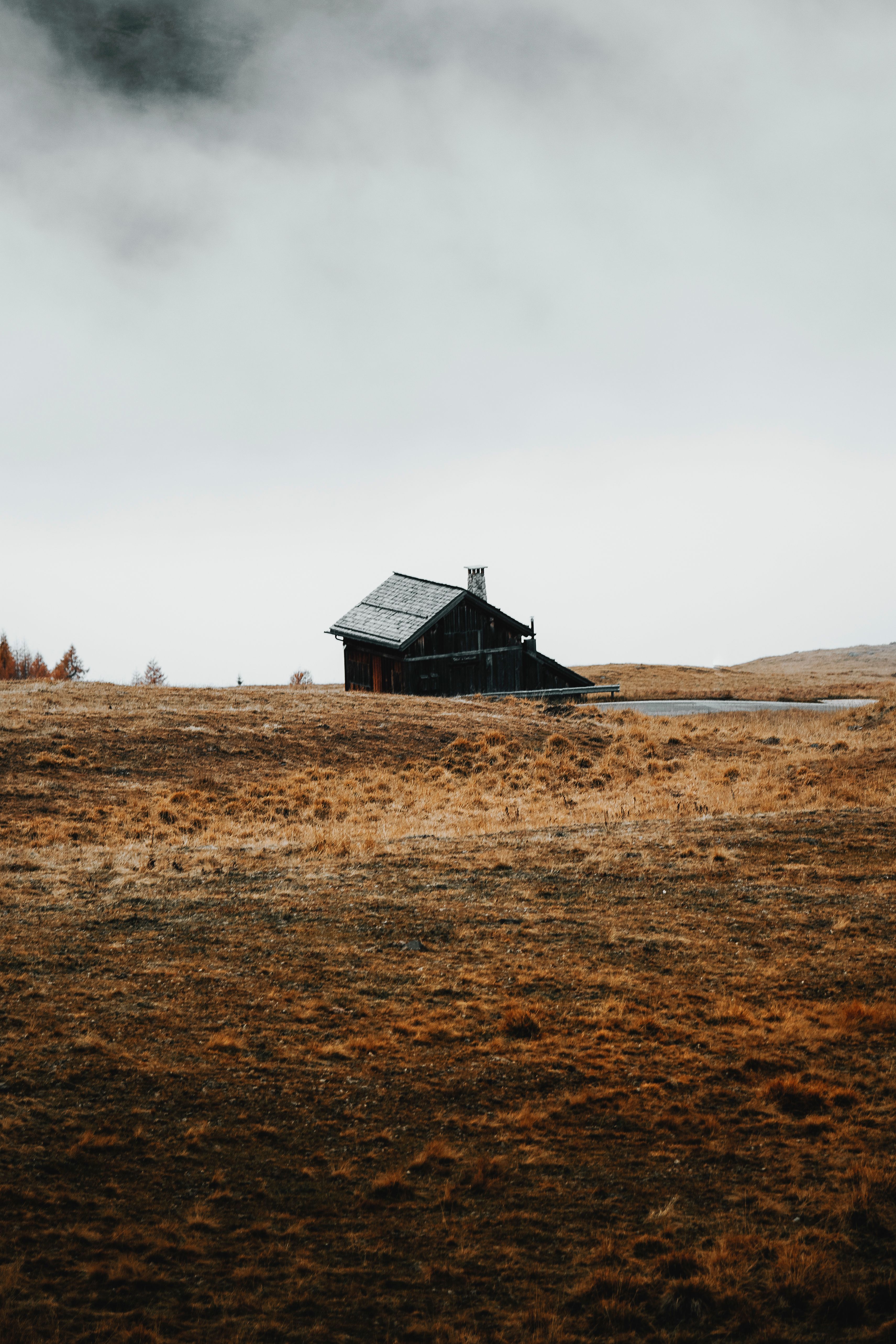 A Wooden House on a Dry Grass Field · Free Stock Photo