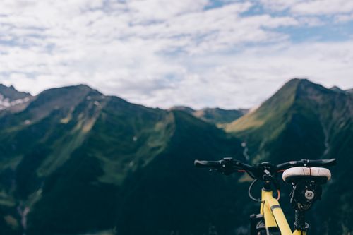 Free Explore breathtaking mountain landscapes with a close-up of a bicycle. Stock Photo