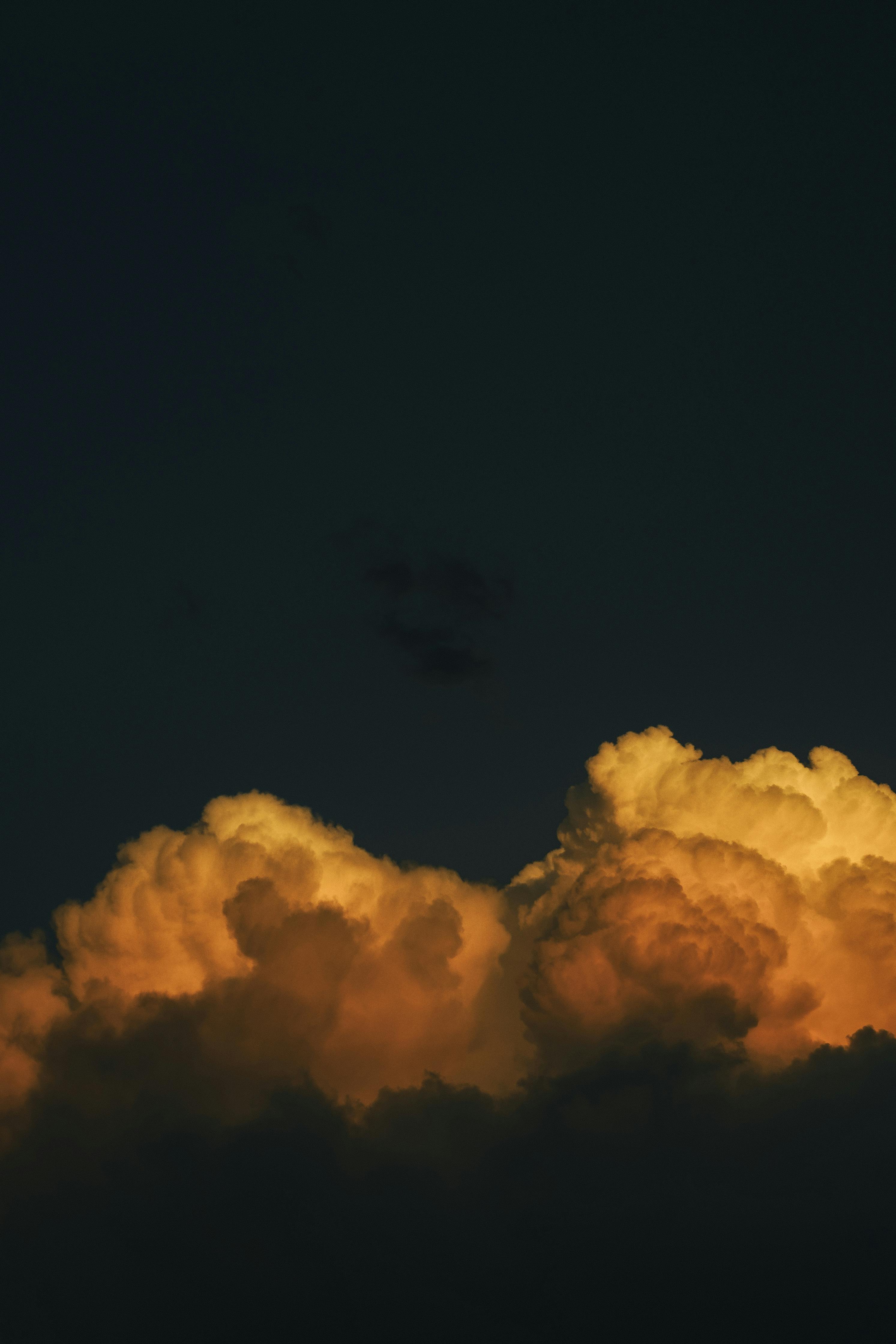Vibrant cloudscape during twilight with dramatic light and color contrast.