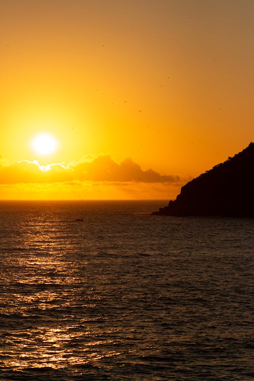 Yellow Sky over Sea Coast at Sunset