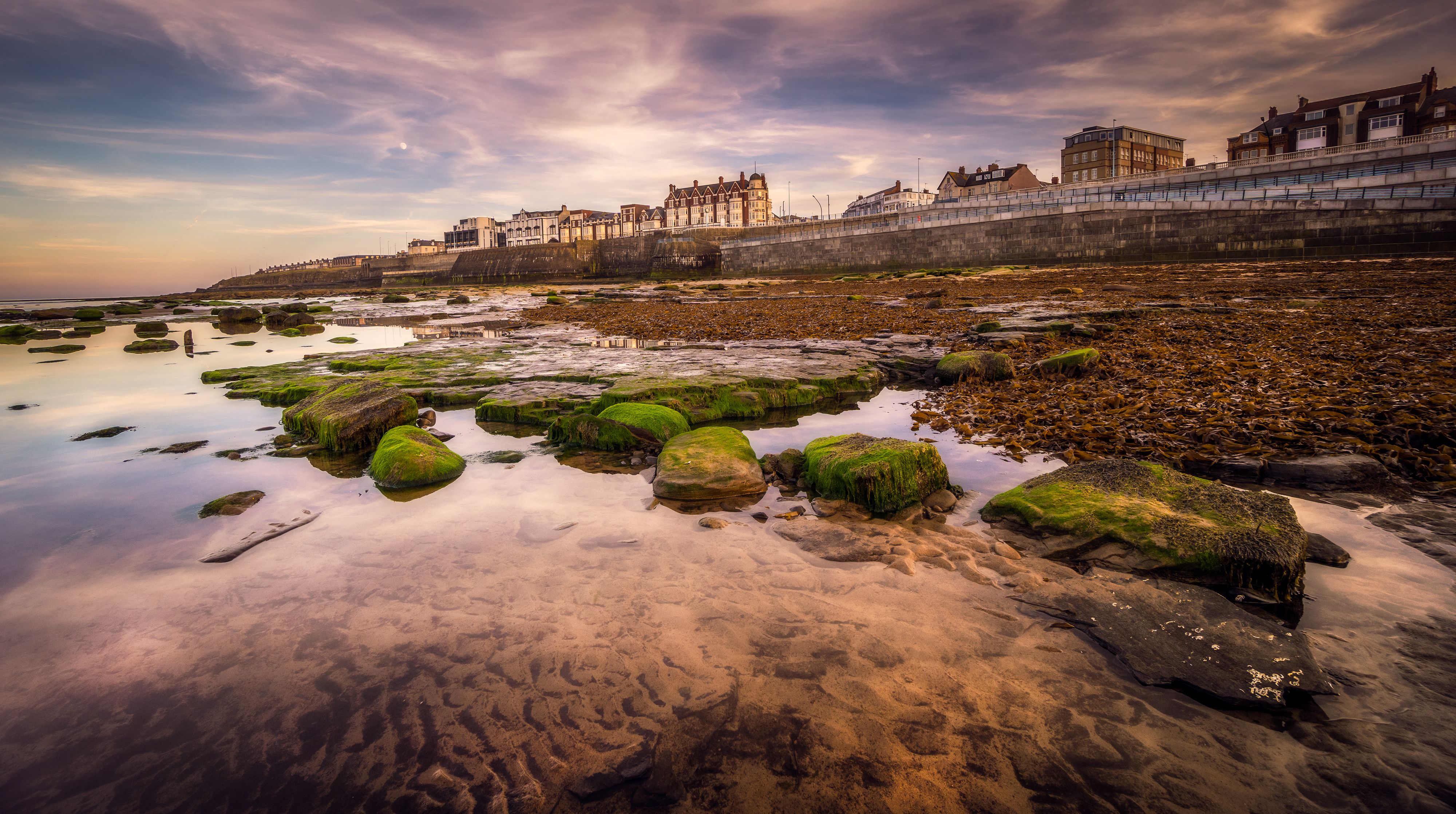 Whitby harbour and the abbey ruins on the East Cliff at low tide