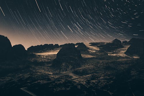 Long Exposure Photo of Starry Sky above Rocky Landscape