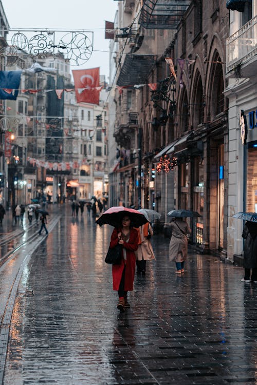 Pedestrians Walking with Umbrellas on the Streets of Istanbul in Rain