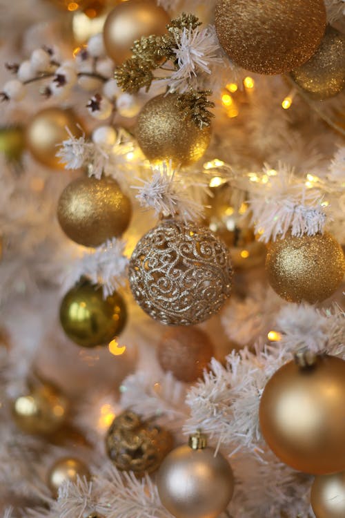 Close-up of a White Christmas Tree with Golden Baubles 