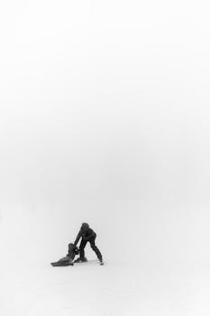 A parent with a child skiing in the misty winter landscape of Crans-Montana, Switzerland.