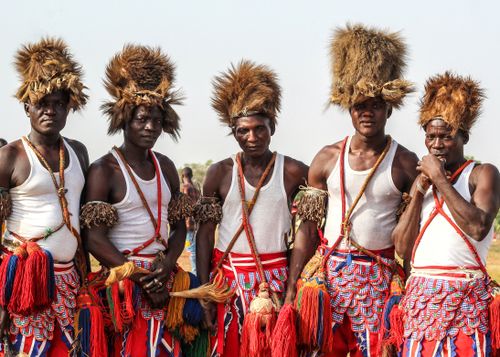 Free A group of Eggon tribal dancers in traditional costumes, posing outdoors during a festival in Nigeria. Stock Photo