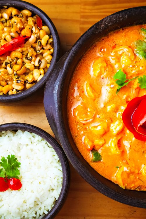 Free Vibrant Indian curry dish served with rice and beans, perfect for a hearty meal. Stock Photo