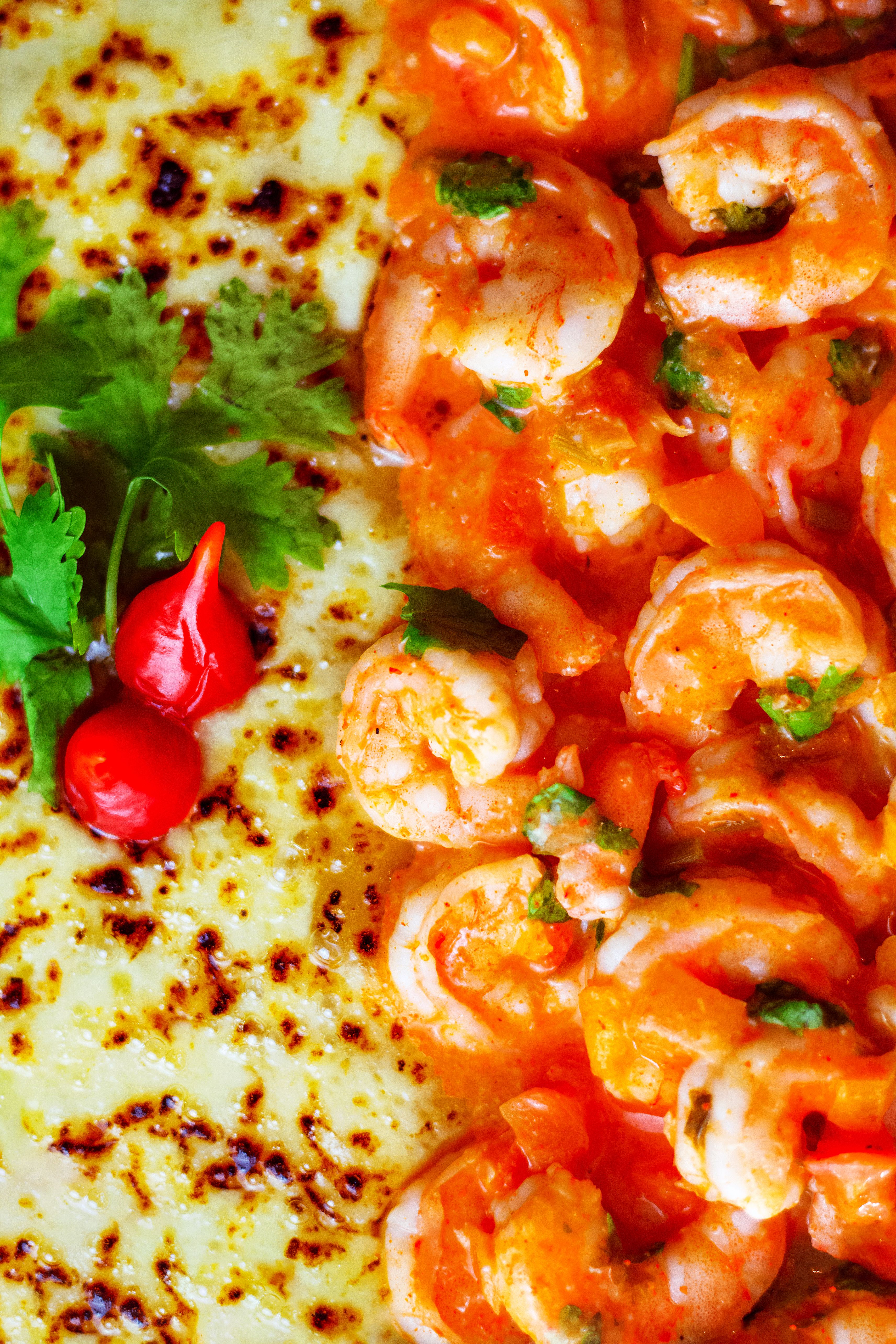 Close-up of a delicious shrimp dish with melted cheese, perfect for a seafood lover's lunch.