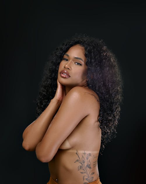 Young Woman with a Tattoo Posing Topless