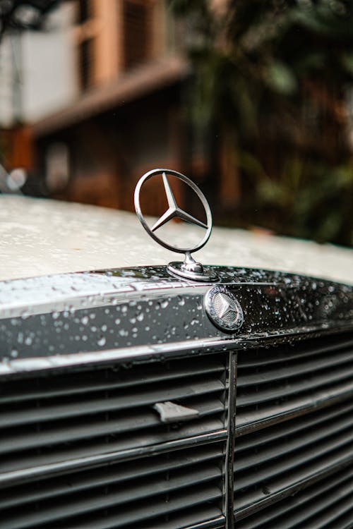 Close-up of the Mercedes Emblem on a Black Car