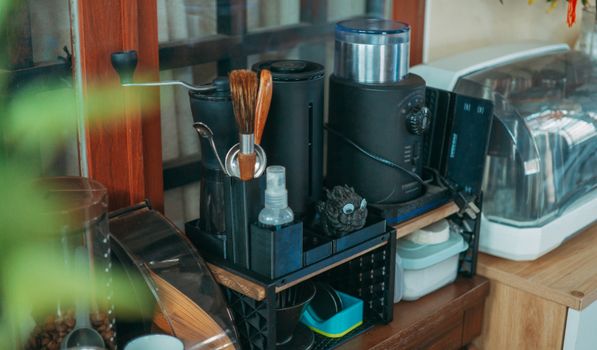 A tidy modern kitchen counter displaying various coffee-making equipment and kitchenware.