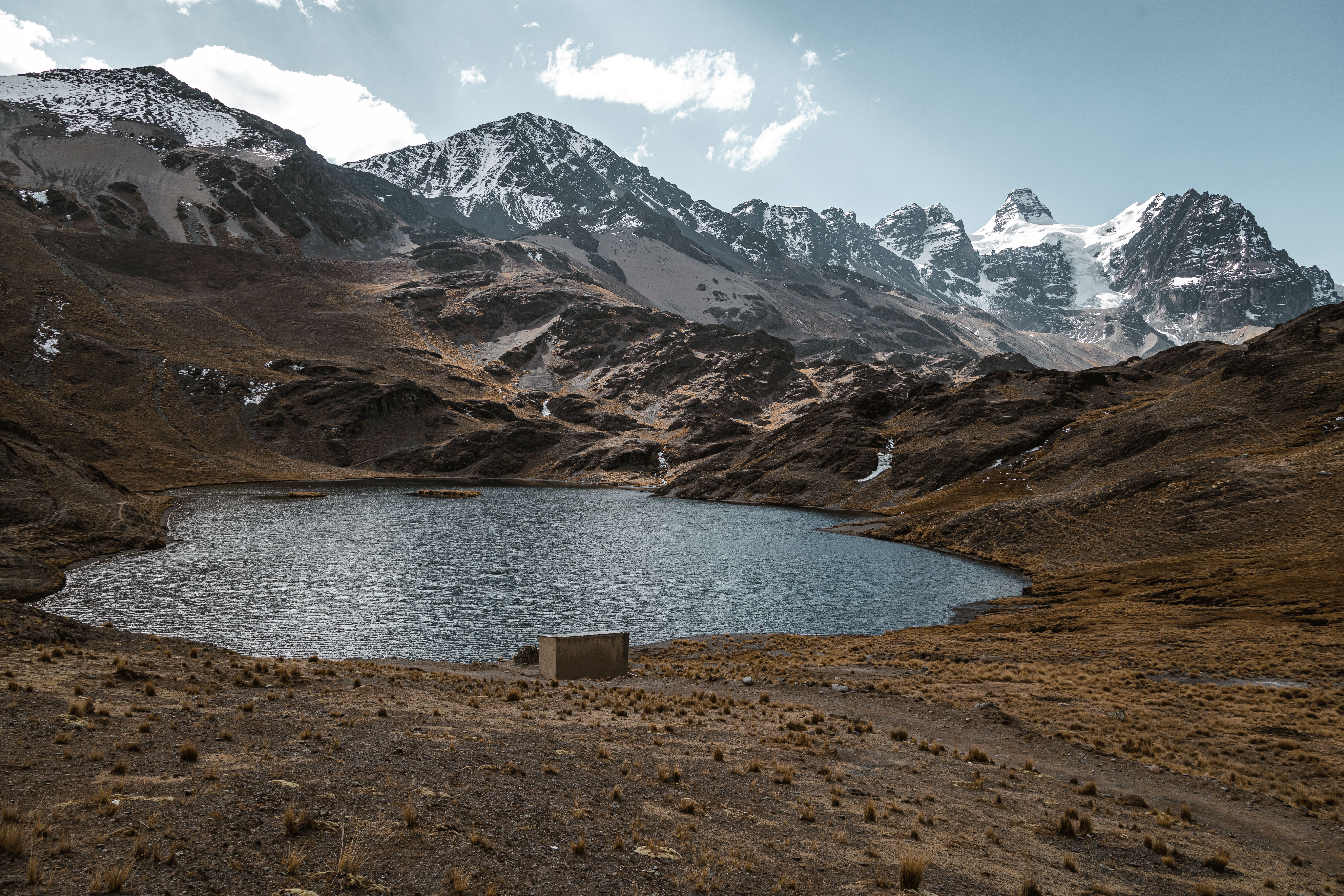 A Breathtaking View Of Condoriri Mountains And A Serene Lake In Oruro, Bolivia, Showcasing Natural Beauty.