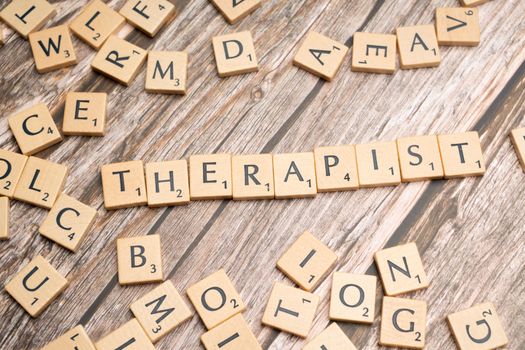 The word therapist spelled out with scrabble letters