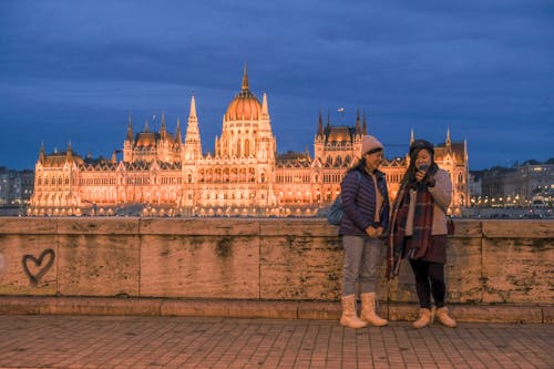 Women Standing by Wall and with Orszaghaz behind