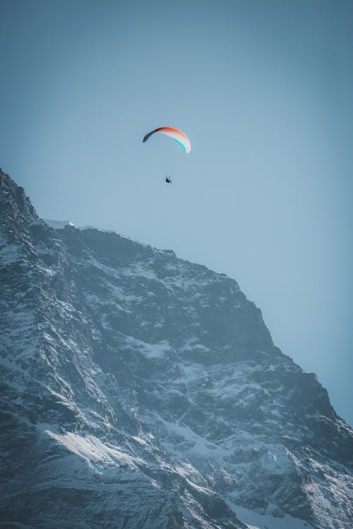 Glide Flying over Snowed Mountains