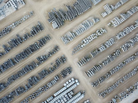 High angle view of stacked concrete pipes organized in an outdoor storage yard