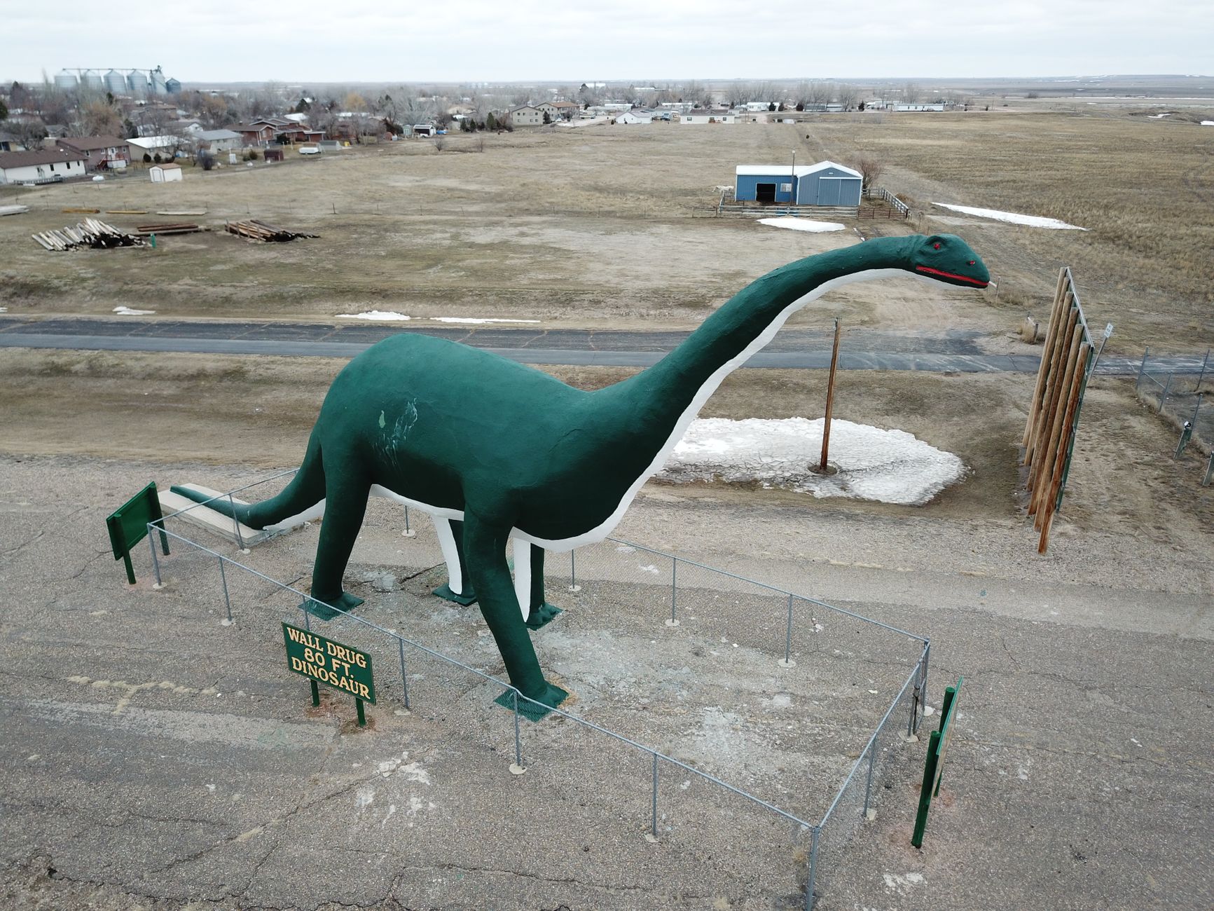 Drone shot of the iconic 80ft Wall Drug dinosaur in Wall, South Dakota.