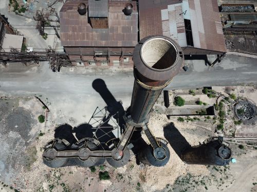 Free Aerial photo showcasing industrial chimneys and buildings, highlighting industrial architecture. Stock Photo