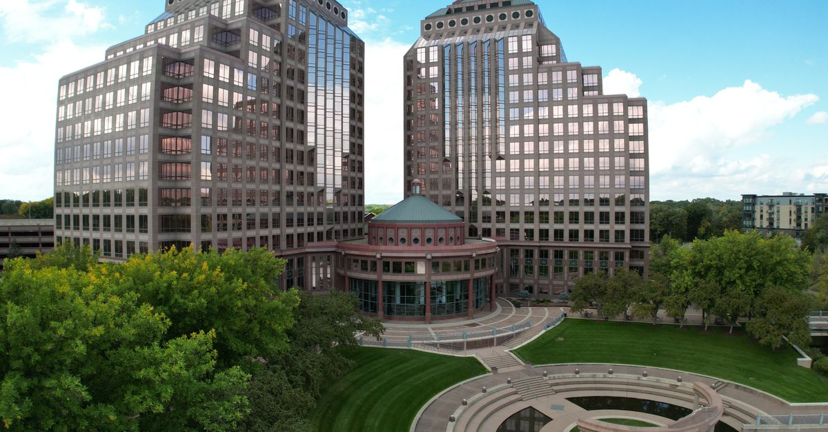 Modern office towers in a cityscape with landscaped garden. Captured from an aerial perspective.