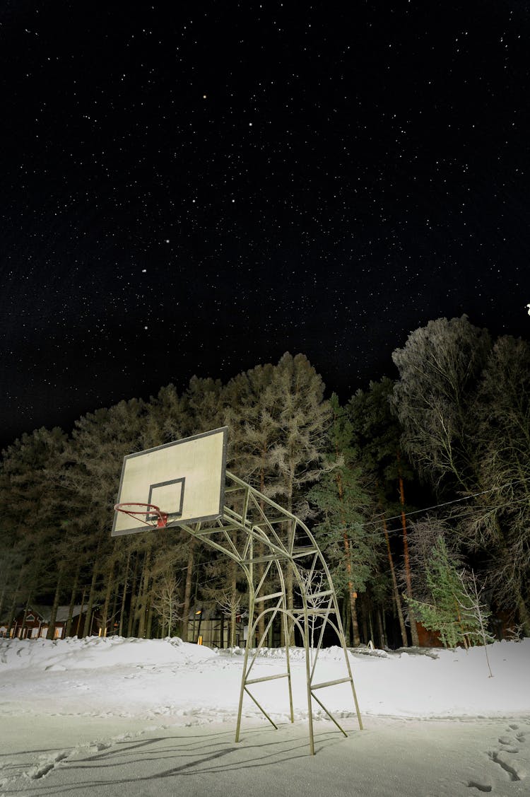 Night Sky Over A Basketball Court Covered With Snow