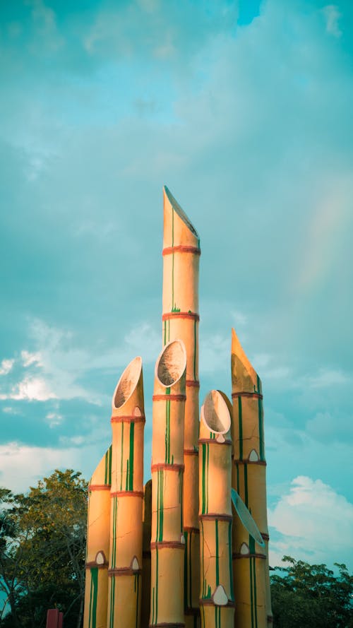 Free A tall tower with a rainbow in the sky Stock Photo