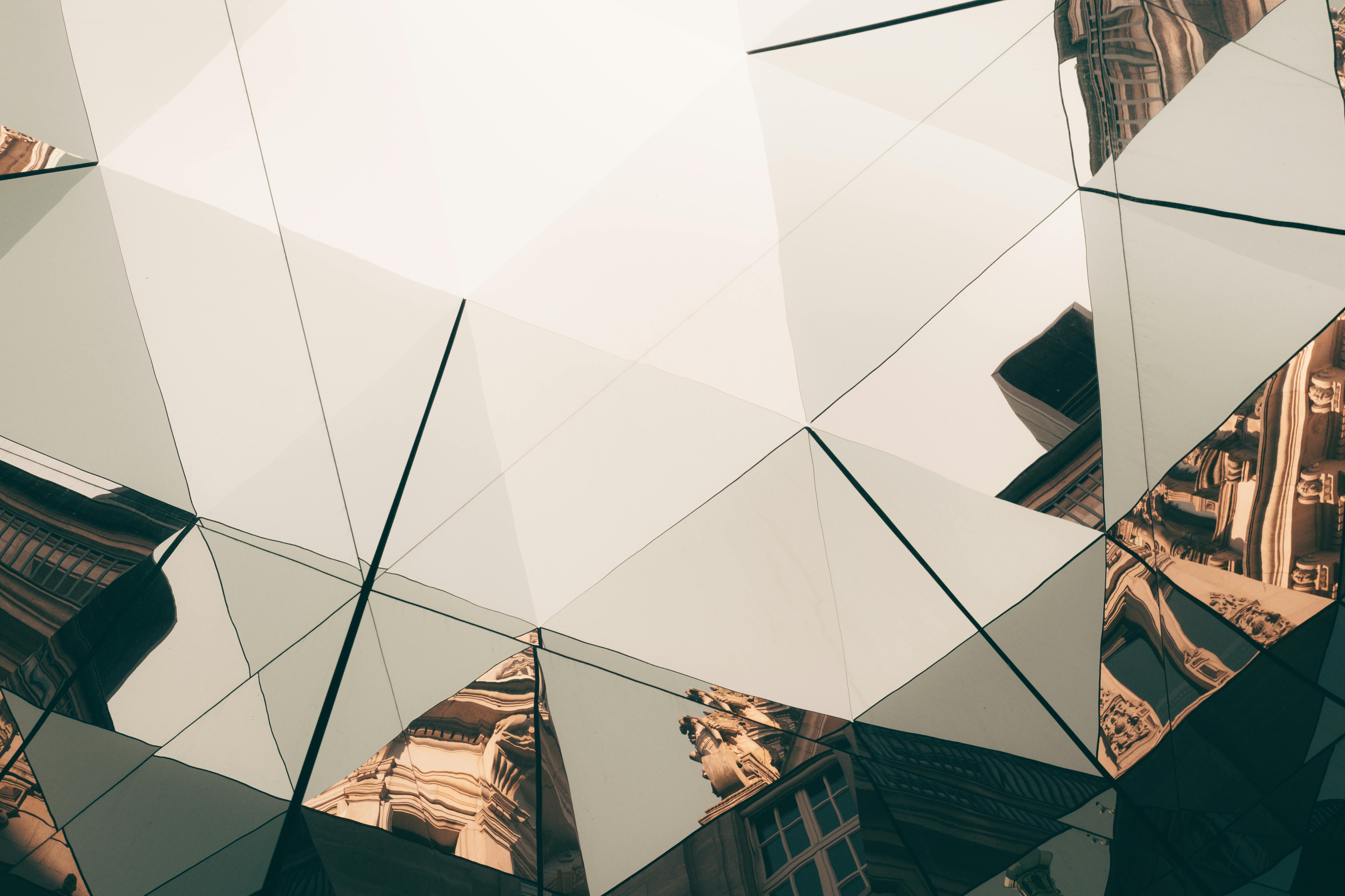 Geometric glass facade of a building in Hamburg reflecting urban architecture.