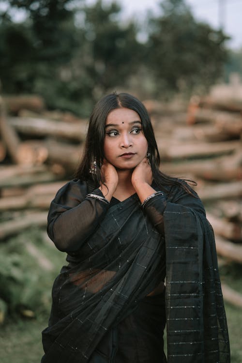 Young Woman in a Dark Saree Posing Outside 