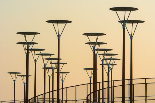 Free Silhouettes of modern street lights against a sunset sky in Zoetermeer, Netherlands. Stock Photo