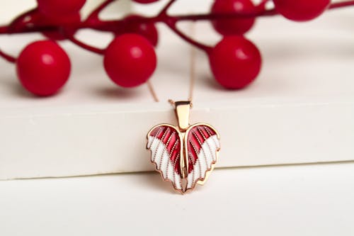 Free Opening Pendant in the Shape of Wings Covering the Heart Stock Photo