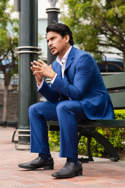 Man in Blue Suit Sitting on Bench