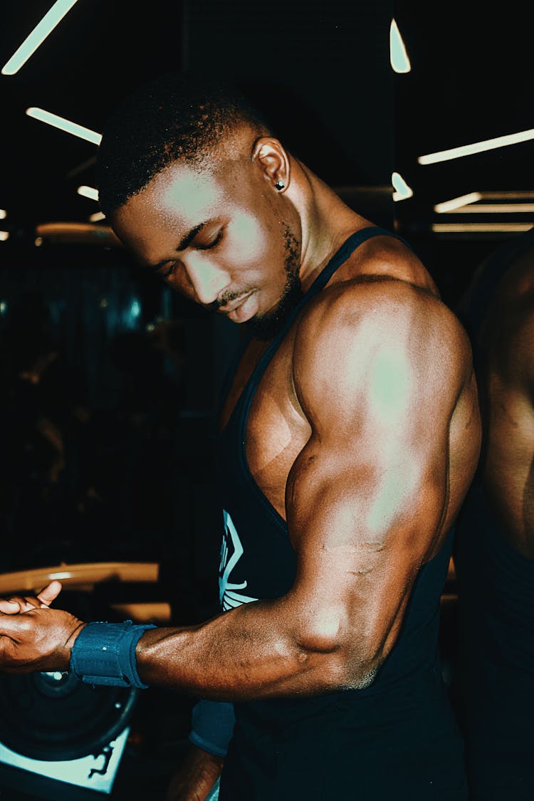 Man In Tank Top Holding Dumbbell