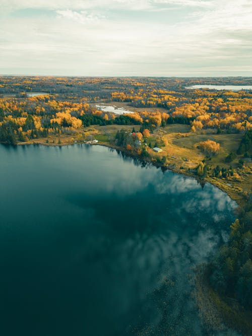 Lake and Autumn Forest on Plains behind