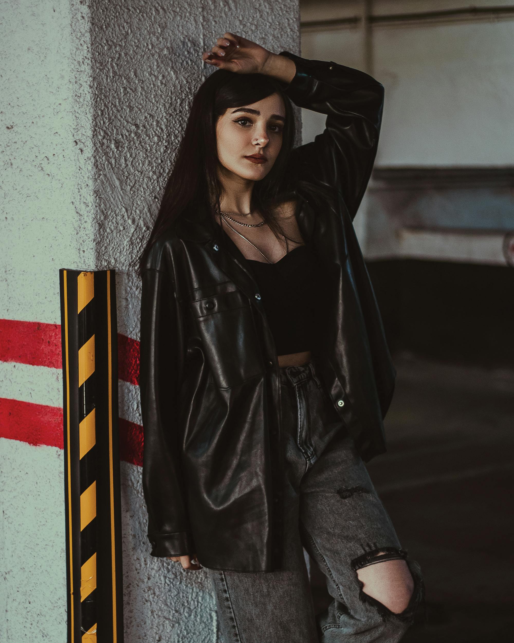 Woman in a Leather Jacket Leaning her Chin on her Hand · Free Stock Photo