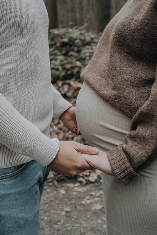 Pregnant Couple Holding Hands