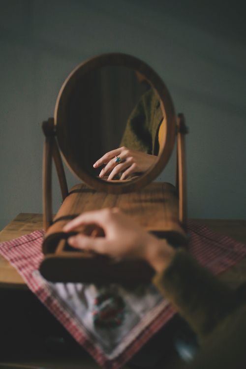 Reflection of a Womans Hand with a Blue Stone Ring · Free Stock Photo