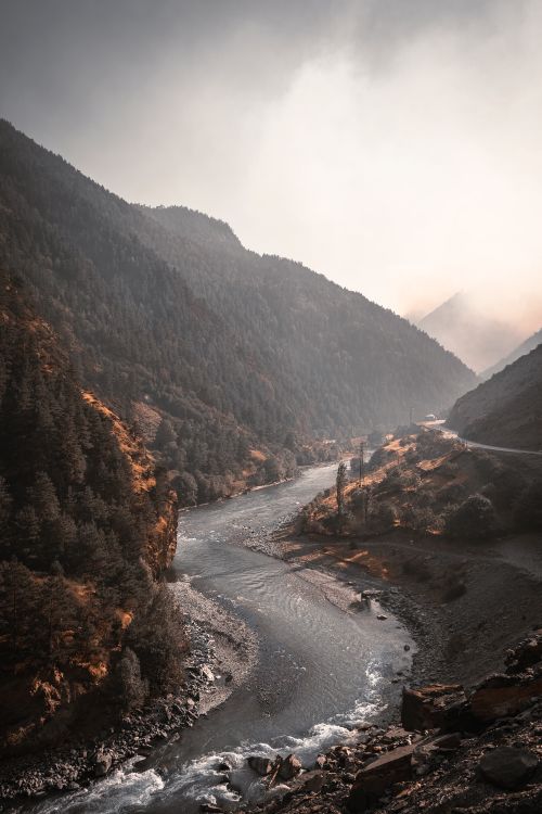 Free Serene view of a river winding through misty mountain valleys in Dagestan, Russia during fall. Stock Photo