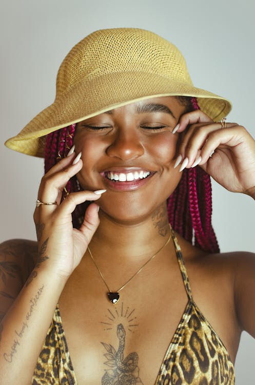 Young Woman with Braided Hair Wearing a Bikini Top and a Hat 
