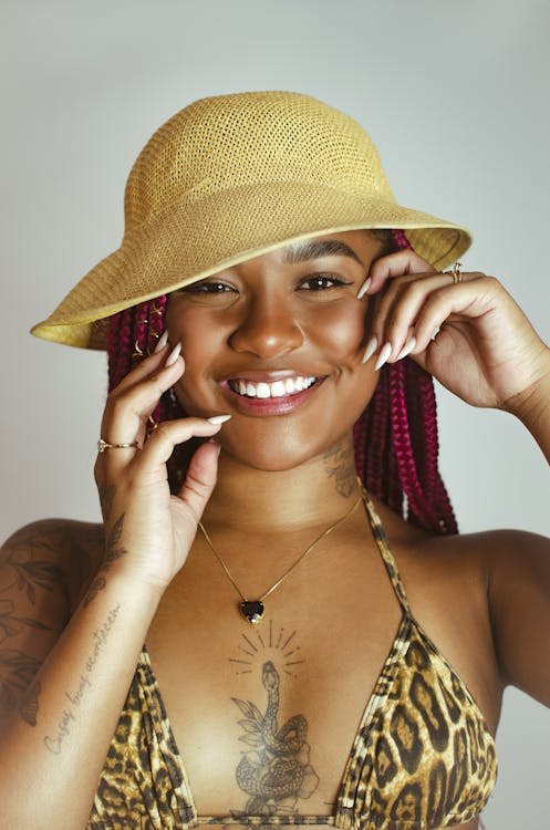 Young Woman with Braided Hair Wearing a Bikini Top and a Hat 