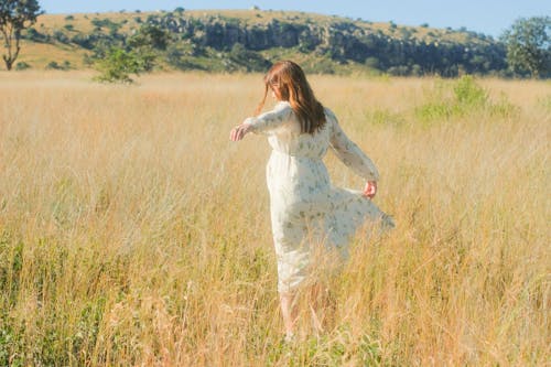 Woman Wearing White Dress on a Field in Summer 
