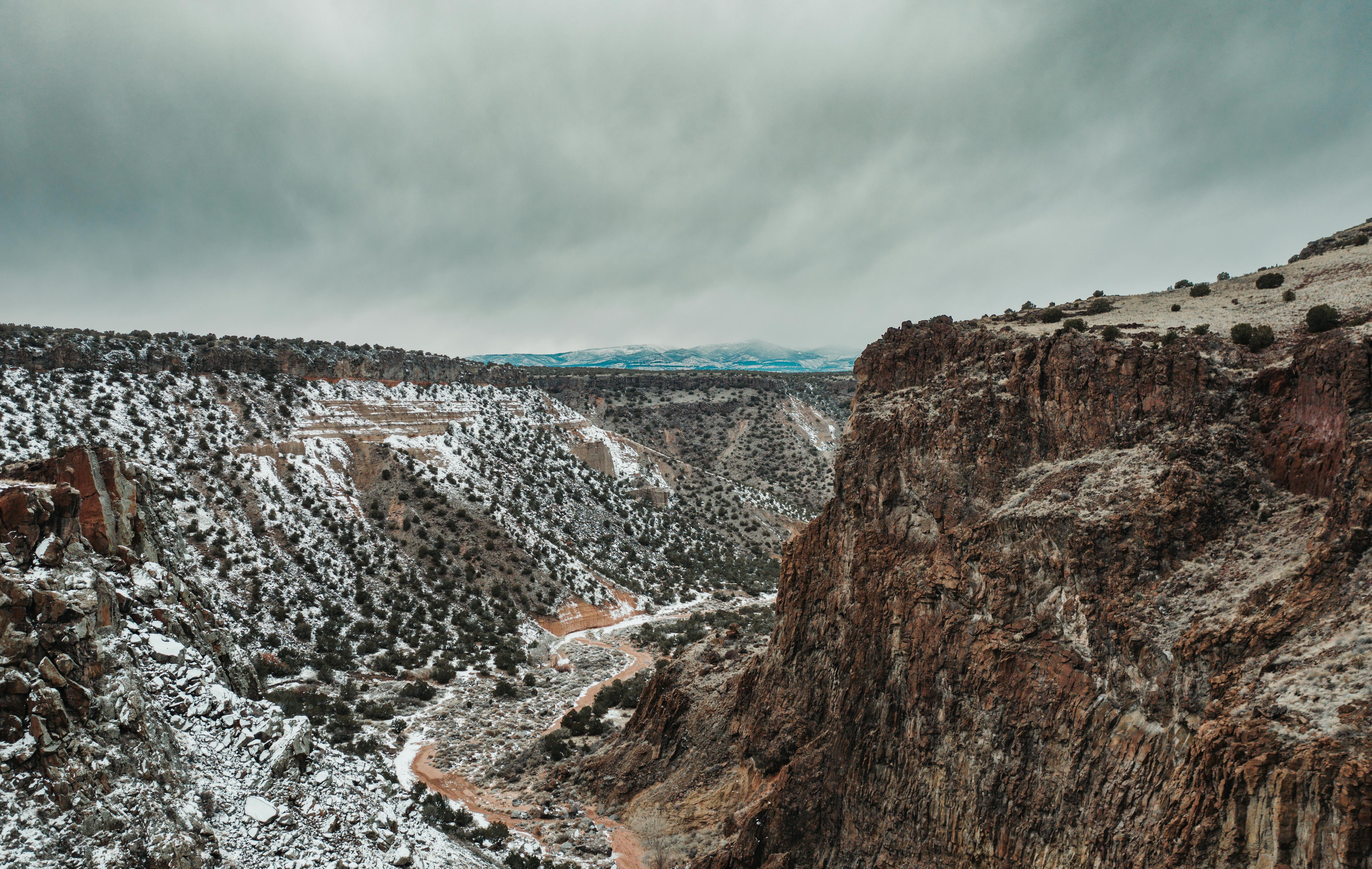 Prescription Goggle Inserts - A breathtaking aerial view of a snow-dusted canyon landscape in White Rock, NM.