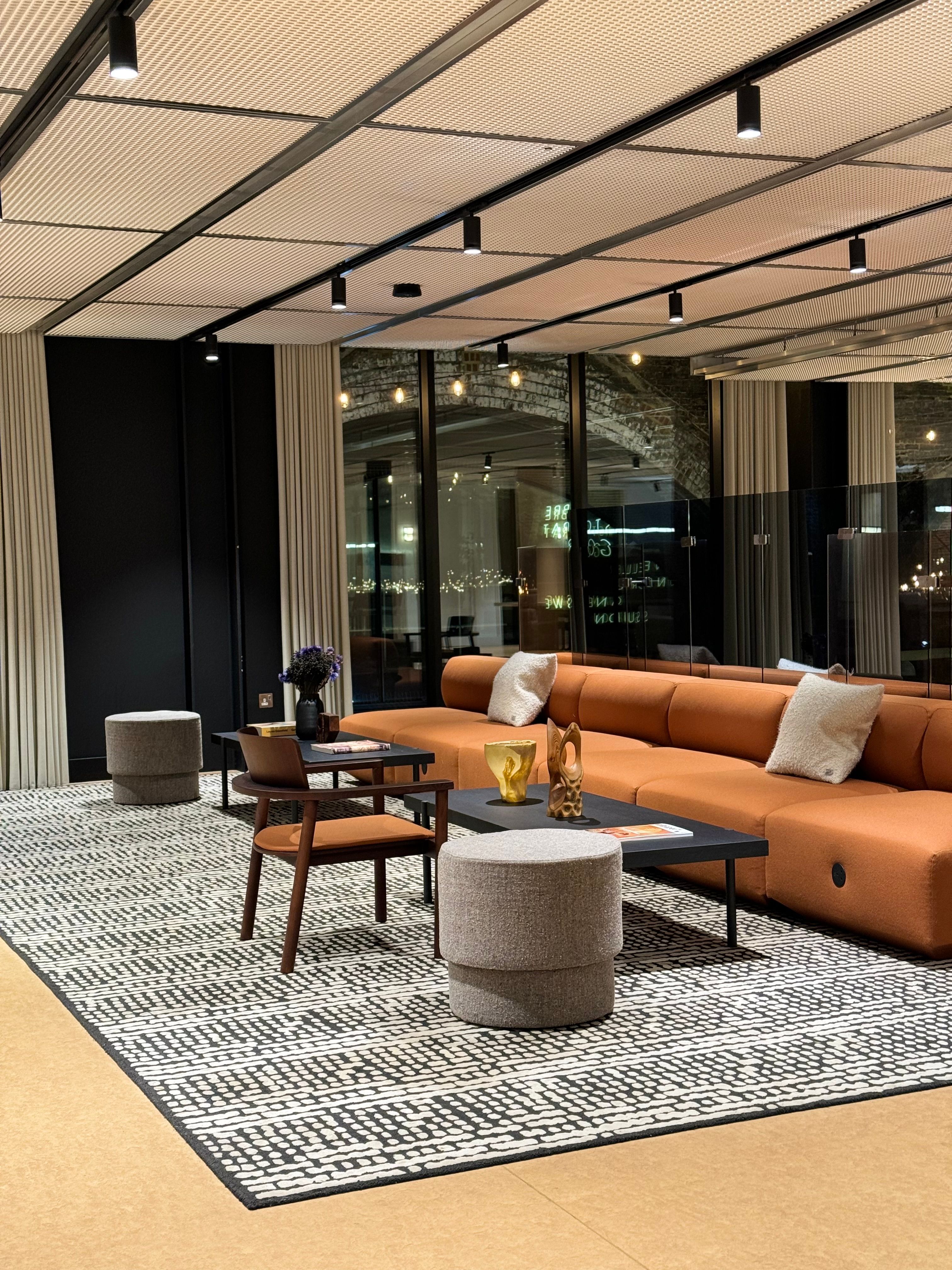 Elegant luxury living room featuring a tailored sofa, marble side table, and designer lighting