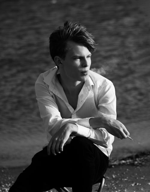 Young Man in White Shirt Smoking Cigarette