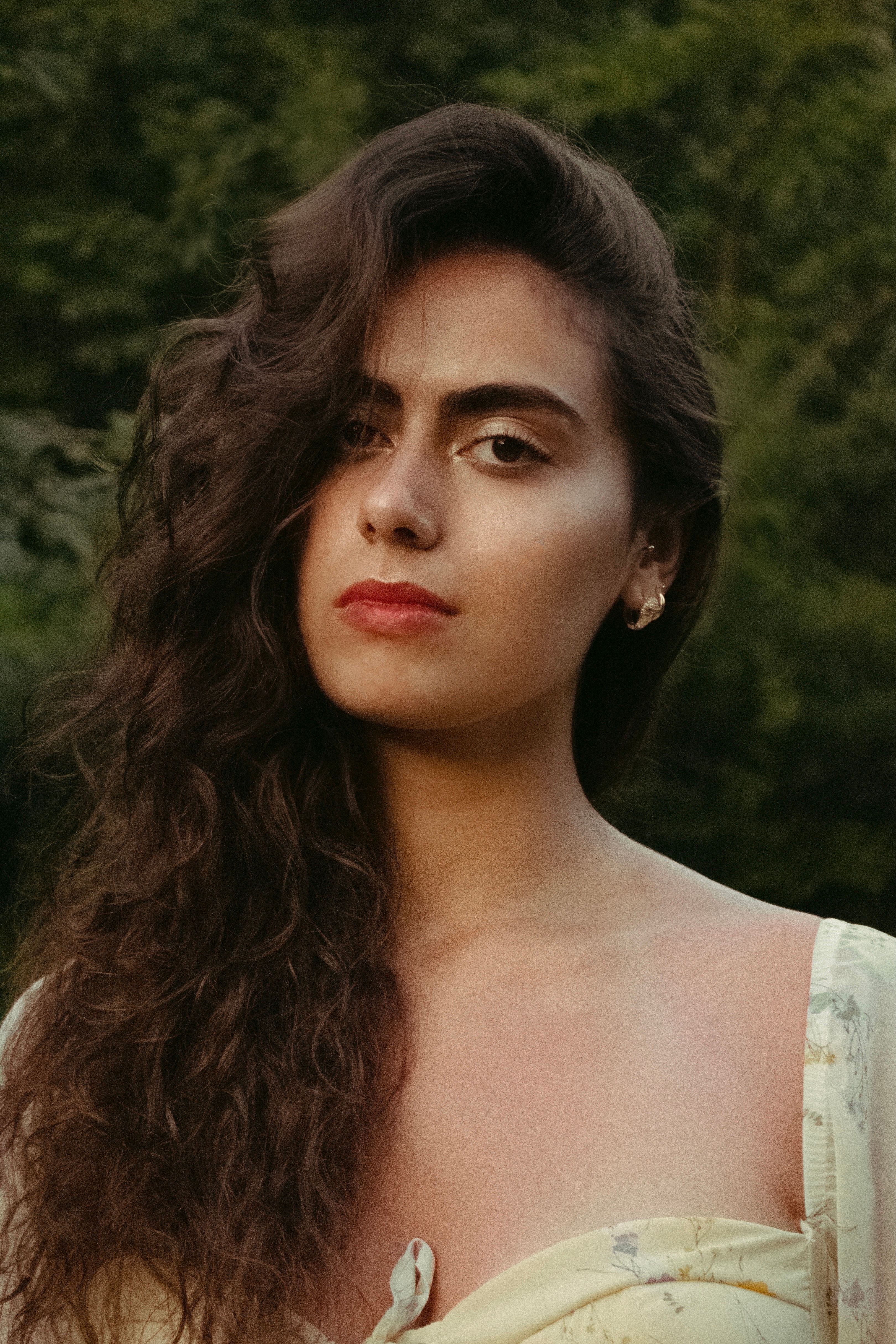 Portrait of a Young Woman with Wavy Hair · Free Stock Photo