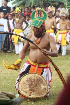 A man in cultural attire performs the traditional Caci dance in Badjo, Indonesia. - Fotografer Sidoarjo