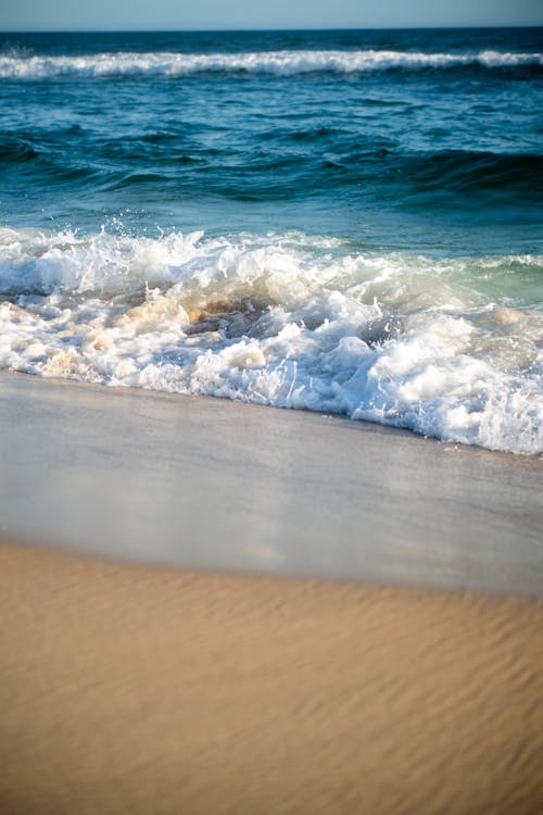 Foamy Wave on a Sandy Beach