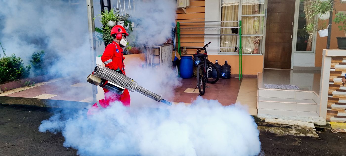 A pest control technician treating a property — recurring pest problems are usually biology, not a failed chemical